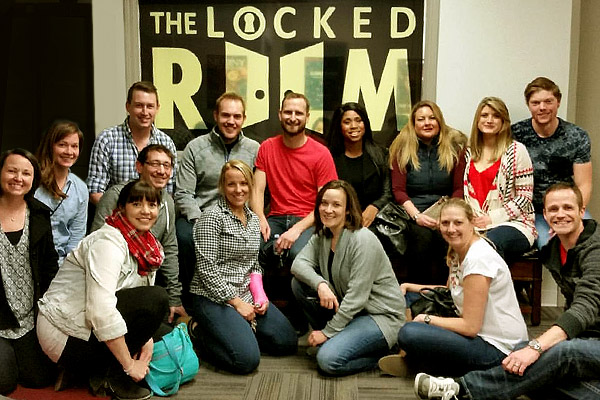 20 people participating at a Locked Room team building event in Calgary.